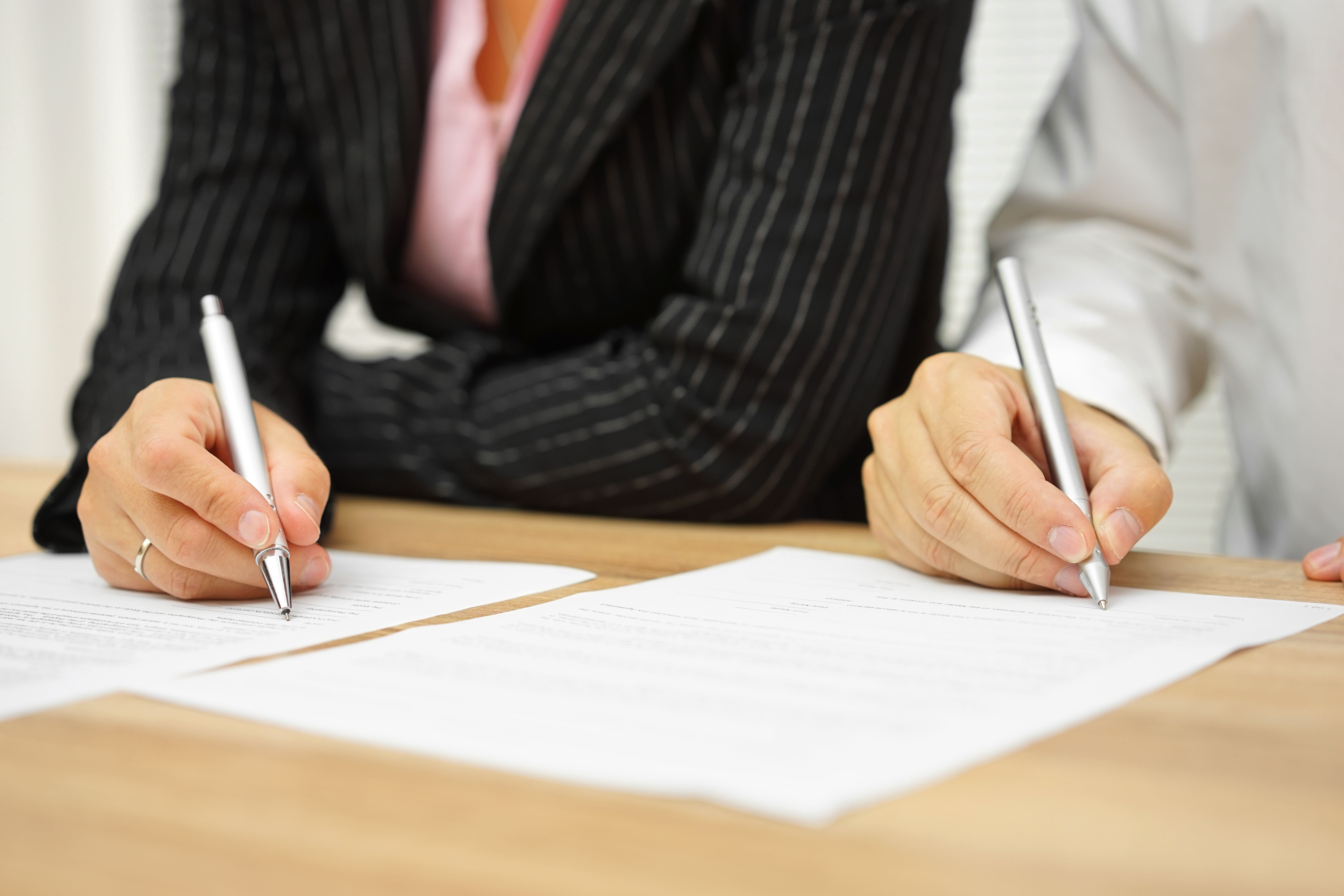 Man and woman signing papers - grounds for legal separation